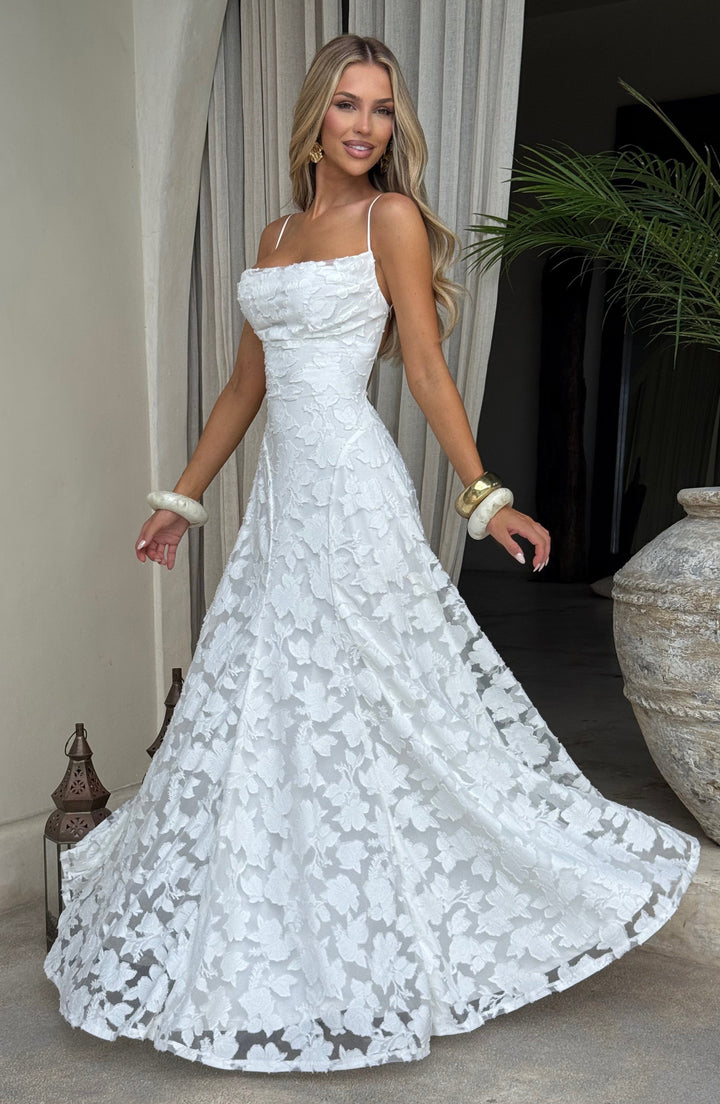 Detailed view of the intricate floral pattern on a women's flowy maxi dress with a waterfall neckline.