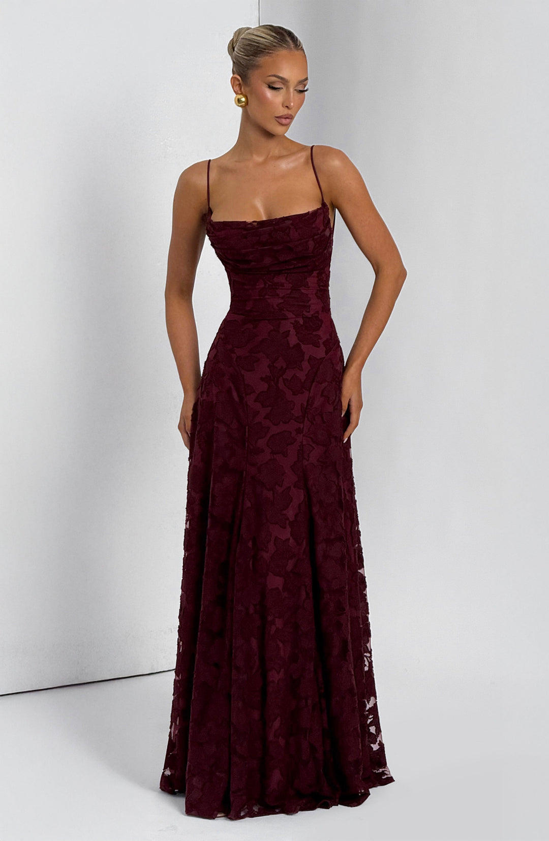 Side profile of the women's floral maxi dress, emphasizing the flowy fabric and waterfall neckline.
