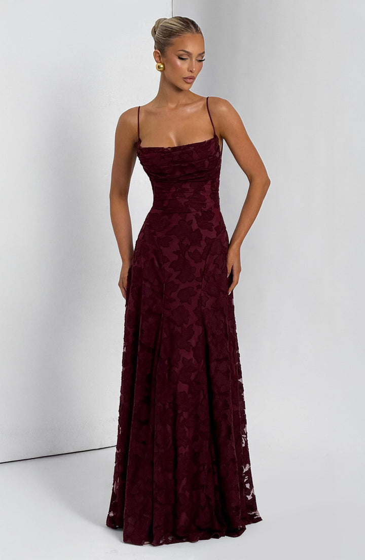 Side profile of the women's floral maxi dress, emphasizing the flowy fabric and waterfall neckline.