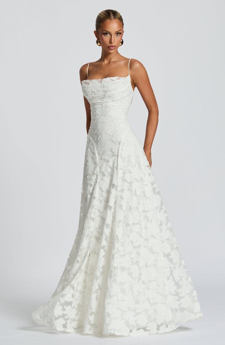 Close-up of the waterfall neckline on a women's elegant floral A-line maxi dress.