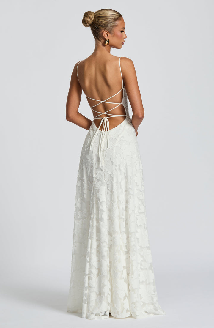 Back view of the women's floral maxi dress showcasing the chic lace-up back detail and flowy skirt.