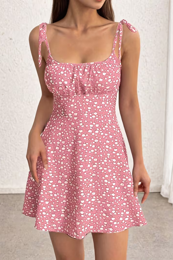 Woman wearing a stylish floral strapless slip dress, showcasing effortless summer party fashion.