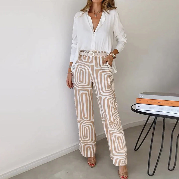 Women's elegant flowing top & patterned trouser matching set. Chic, versatile day-to-night two-piece outfit.