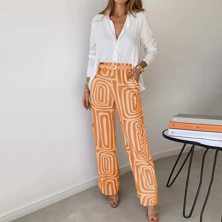 Full view of women's chic two-piece trouser set, featuring a flowing top and stylish patterned pants.