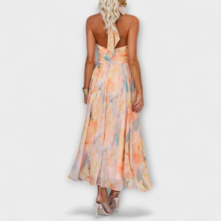 Stylish women's flowing maxi dress featuring a halter neck and open back design, ideal for beach weddings.