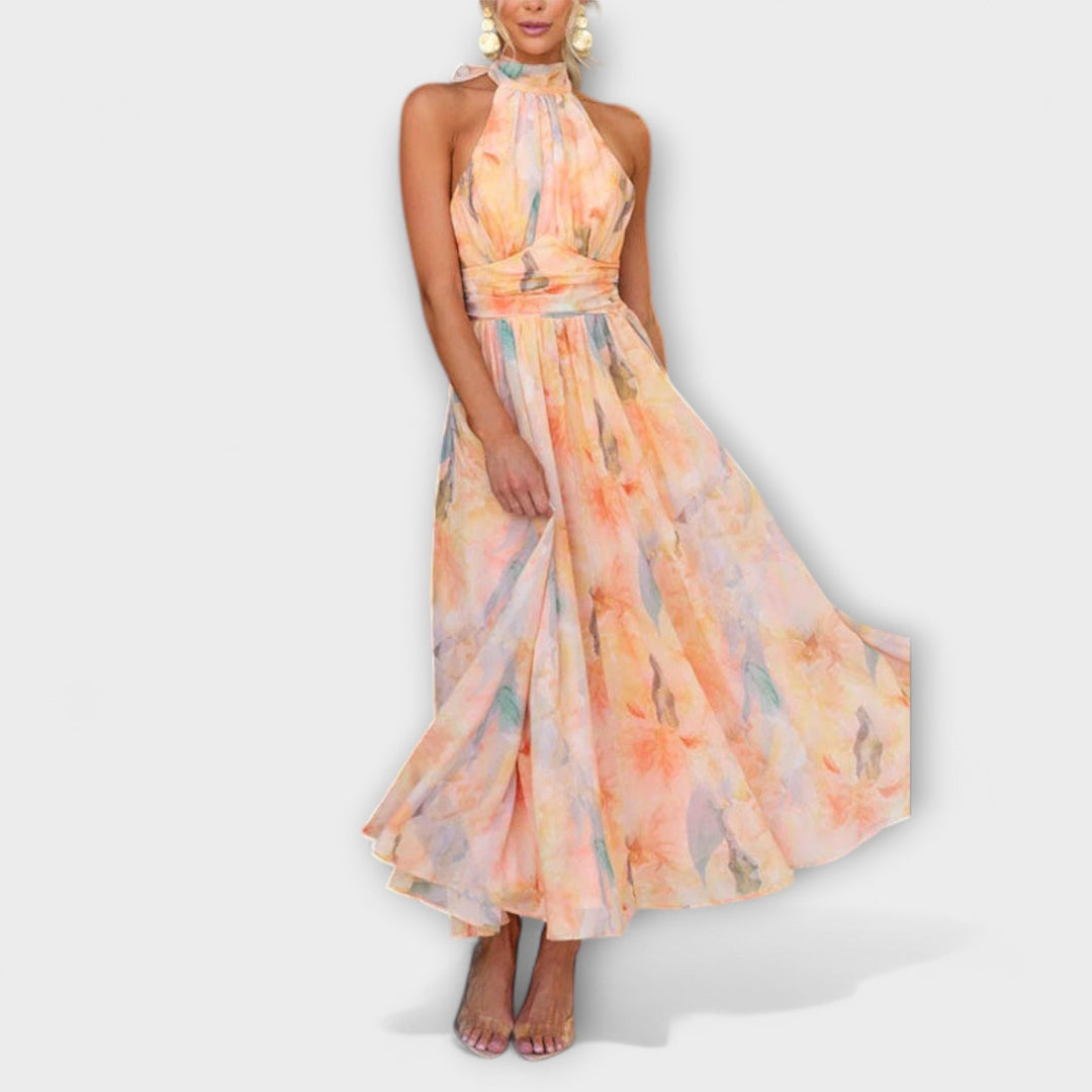 Elegant women's halter maxi dress with vibrant watercolor print, perfect flowing summer fashion.