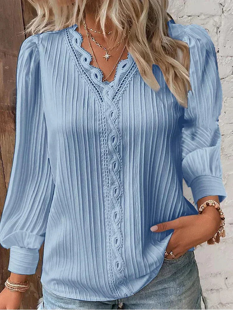 Delicate white lace detail on the elegant women's blouse, highlighting sophisticated craftsmanship.
