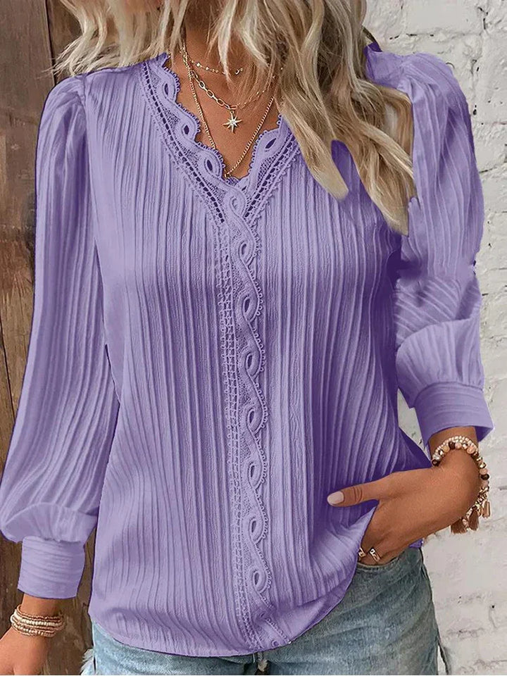 Sophisticated white women's blouse featuring elegant lace accents and stylish puff sleeves.