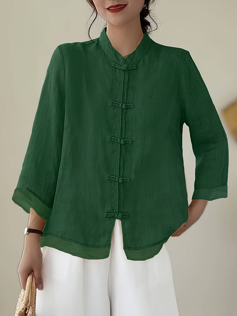 Women's elegant mandarin collar blouse with frog buttons, perfect for office or casual wear.