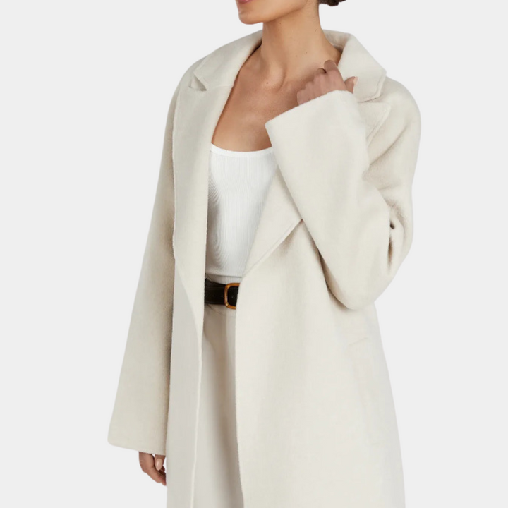 Fashionable women's oversized trench coat, belted for a flattering fit. Elegant and comfortable long outerwear.