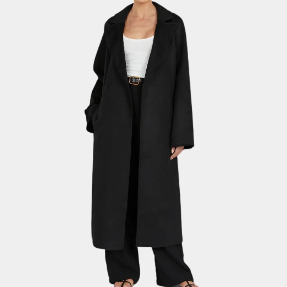 Woman wearing a stylish oversized trench coat with belt, ideal for elegant fall fashion & versatile outerwear.