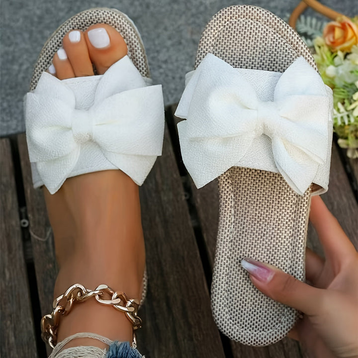Pink women's pearl slide sandals, stylish & comfortable casual flat footwear for summer outings.
