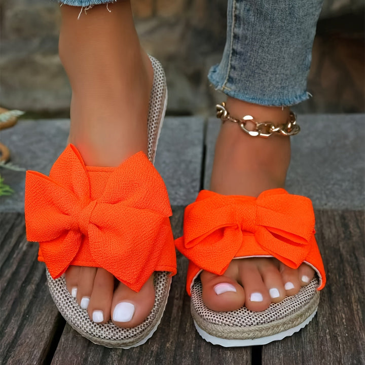 Vibrant women's pearl slide sandals in blue, orange, green. Elegant flat summer casual footwear.