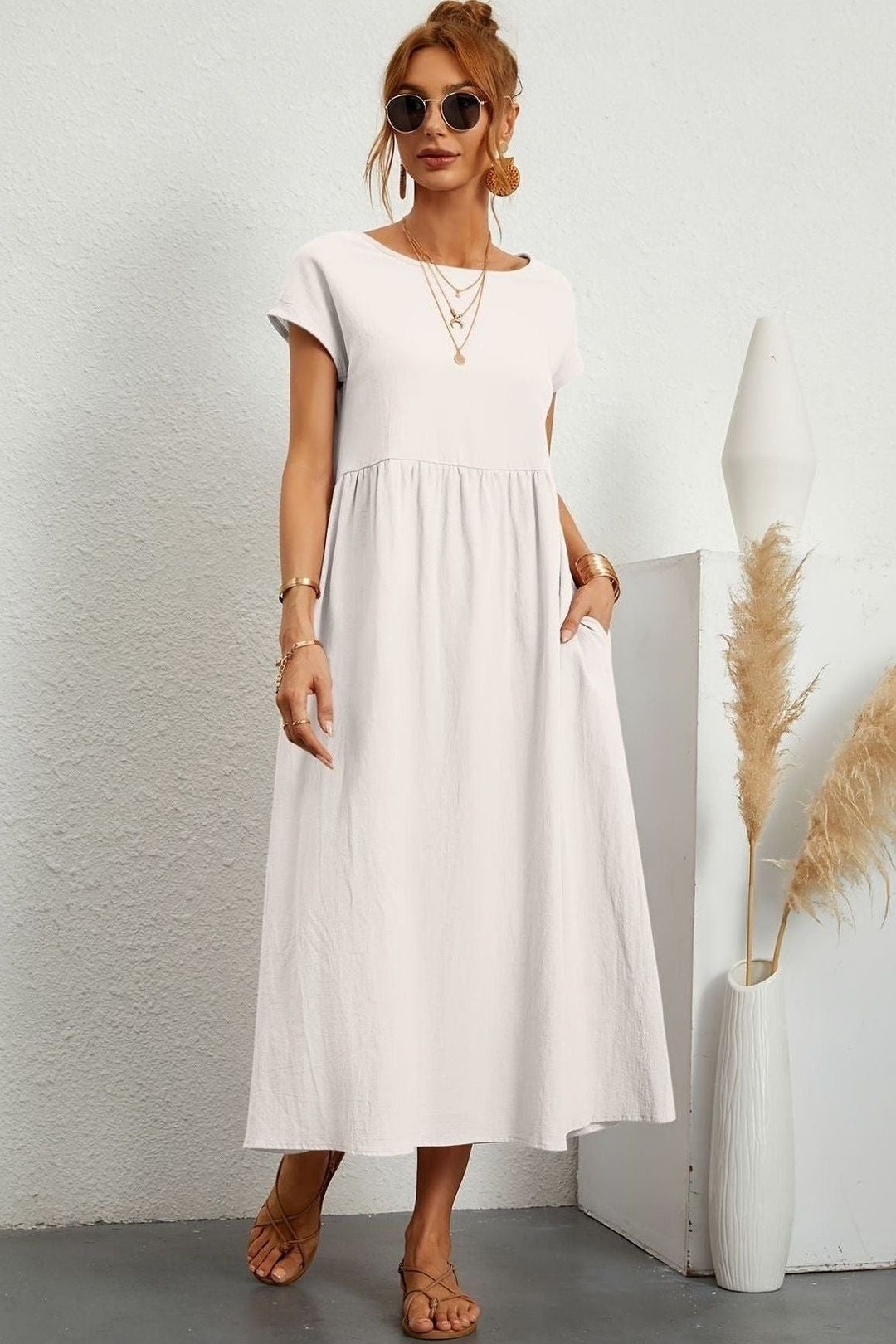 Chic women's midi dress, elegantly pleated, perfect for versatile & comfortable wear. Summer fashion.