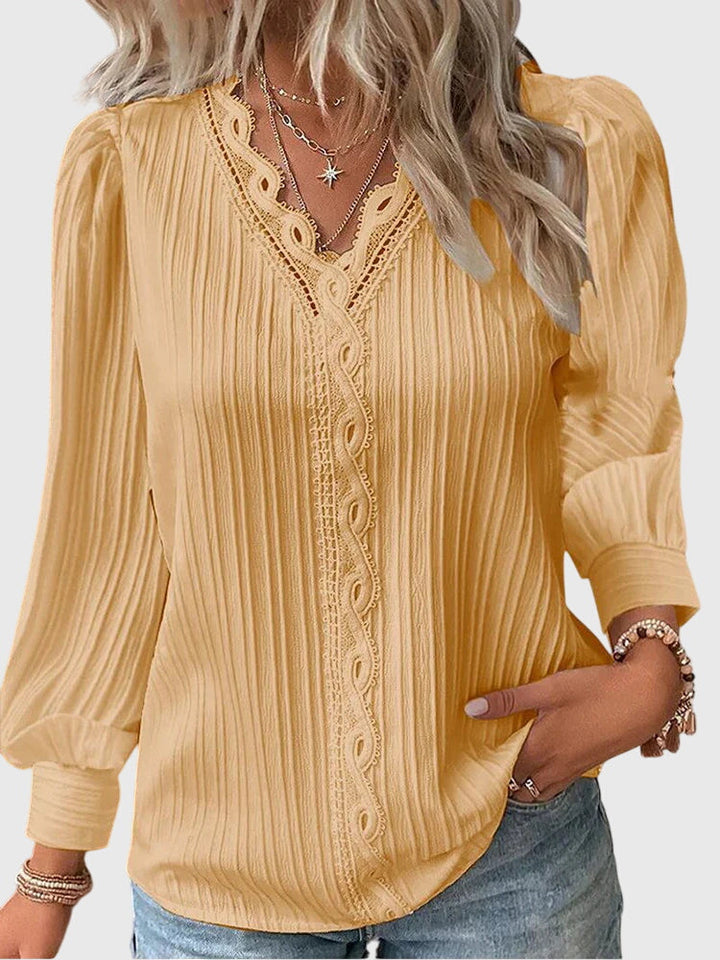 Women's elegant pullover blouse. Chic long sleeve top for versatile wear, perfect for office or casual sophistication.