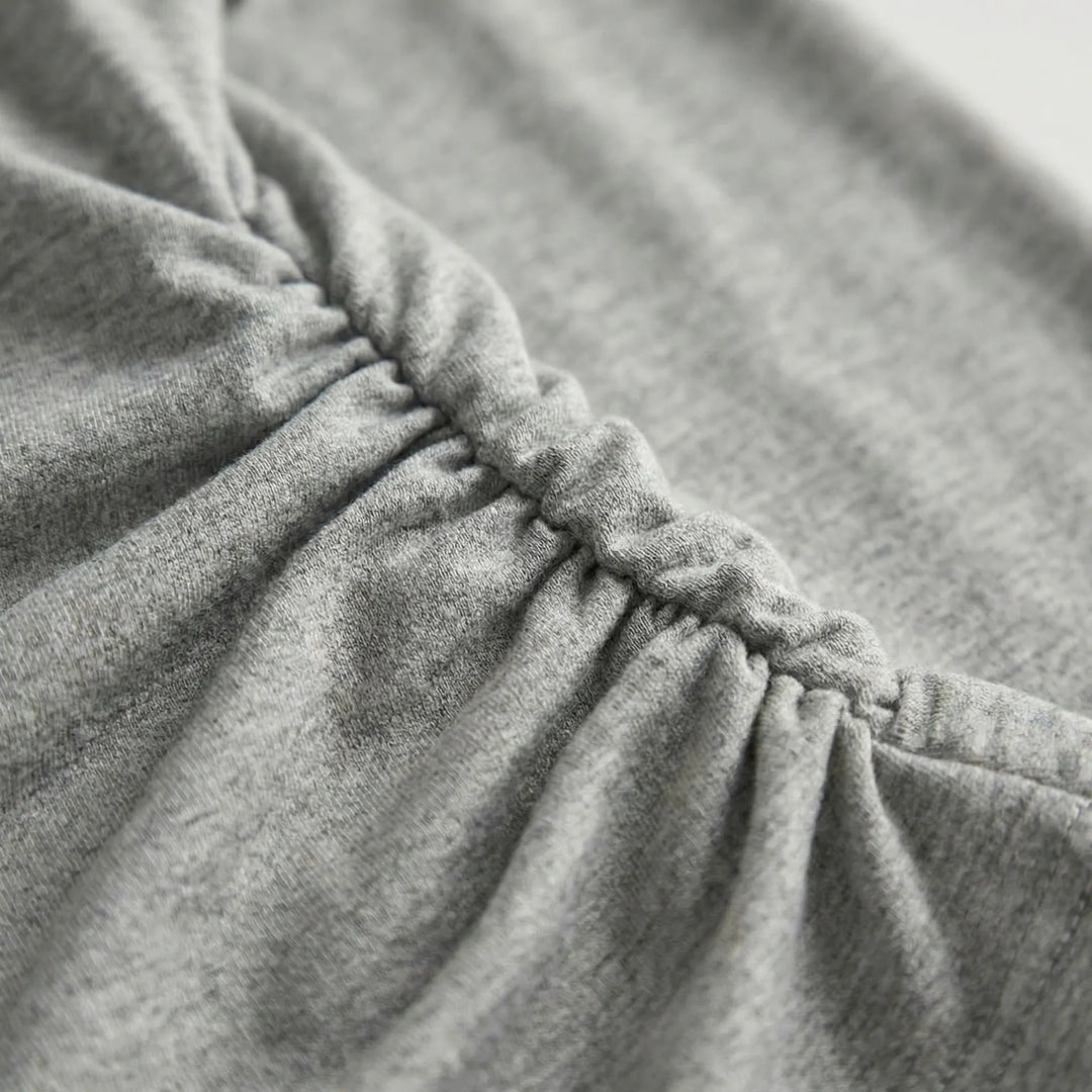Madison pleated long-sleeve top for women. Comfortable fit and elegant design, perfect for casual or dressed-up looks.