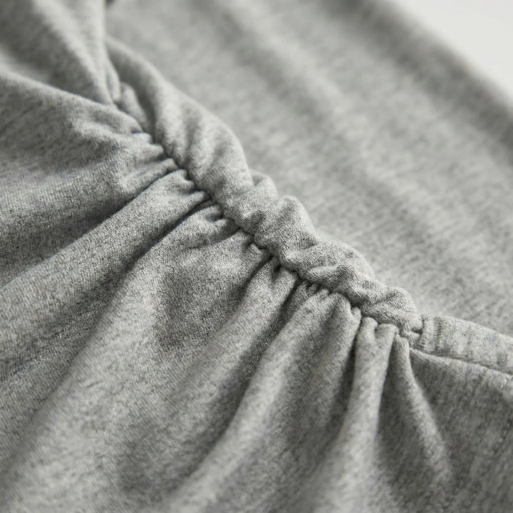 Madison pleated long-sleeve top for women. Comfortable fit and elegant design, perfect for casual or dressed-up looks.