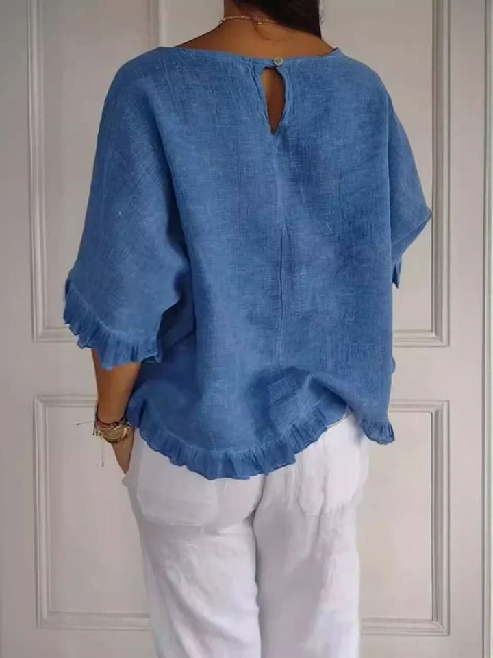 Chic women's ruffle blouse, a versatile summer top. Ideal for a refined casual outfit or professional setting.