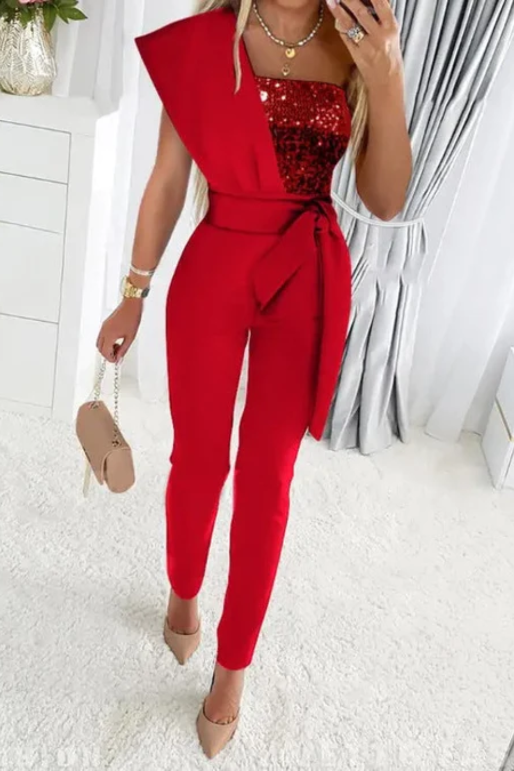 Glamorous woman in a sequin jumpsuit, perfect sparkling party outfit for evening events.