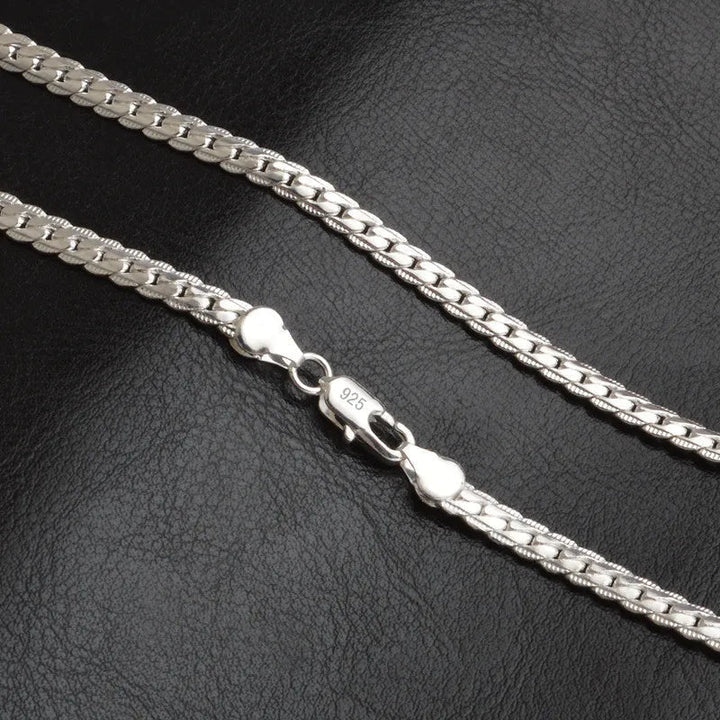Close-up of a delicate women's silver lucky charm necklace, perfect for elegant fashion jewelry and everyday wear.