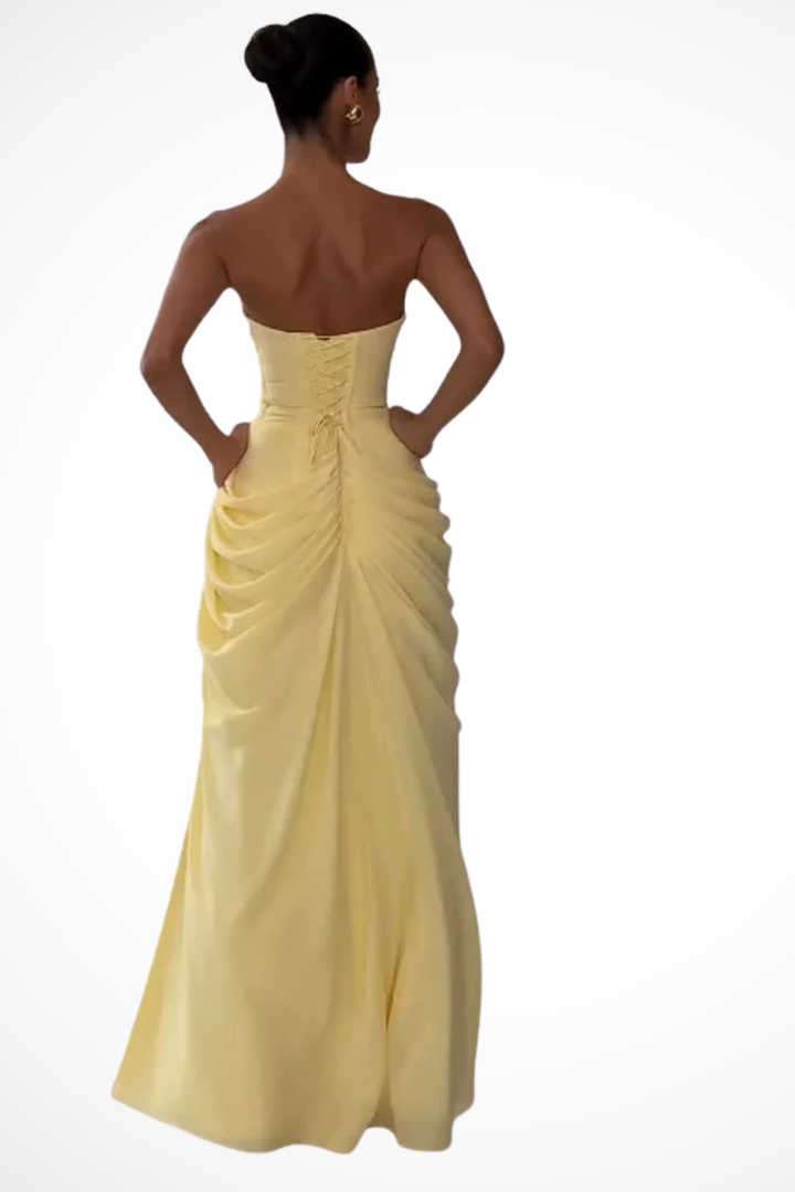 Chic women's strapless evening maxi dress. Features a flattering ruched bodice and a stylish leg slit.