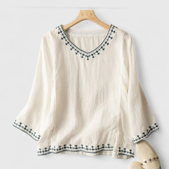 Chic women's pink V-neck blouse with a relaxed fit & long sleeves, ideal for versatile everyday fashion.