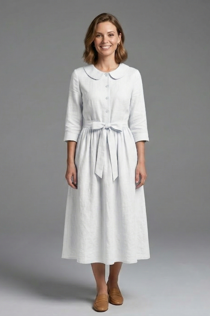 Soft fabric detail of a women's V-neck midi dress with waist tie. Breathable and comfortable summer clothing.