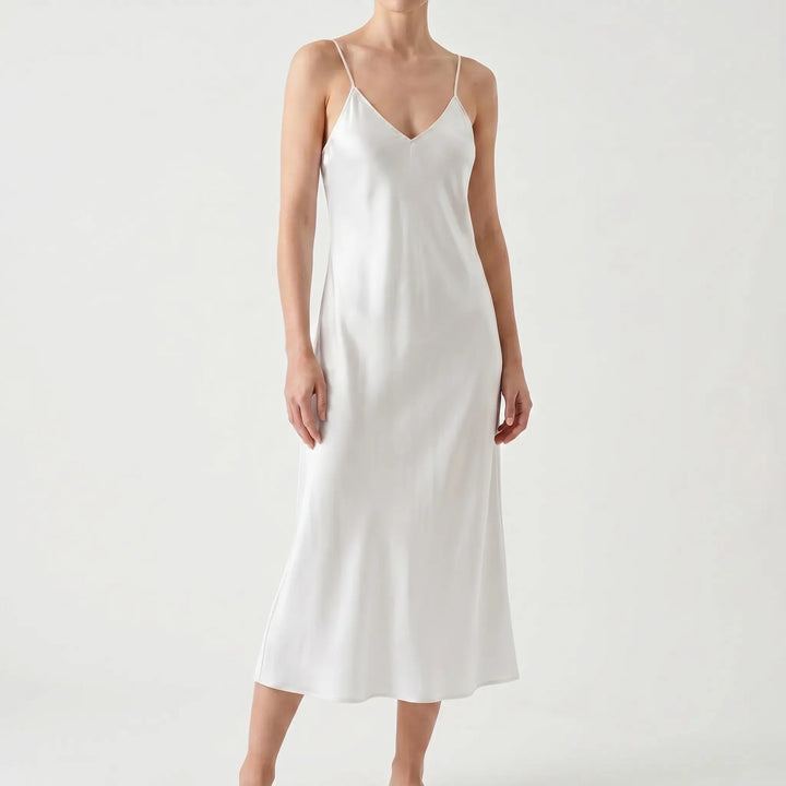 Elegant V-neck slip midi dress with spaghetti straps. A chic women's dress for summer, evening, or party.