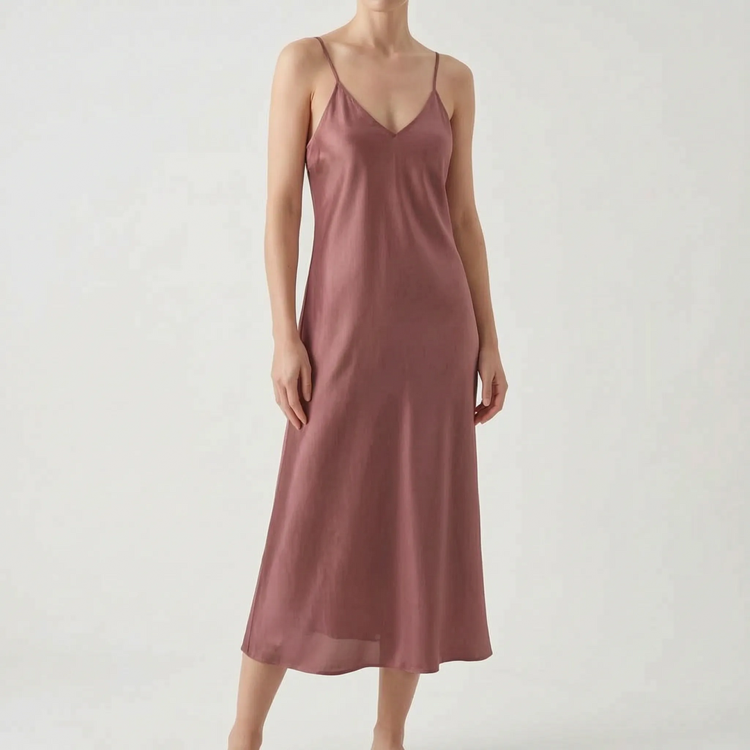 Flowy women's V-neck slip midi dress. Elegant and comfortable spaghetti strap dress for summer wear.