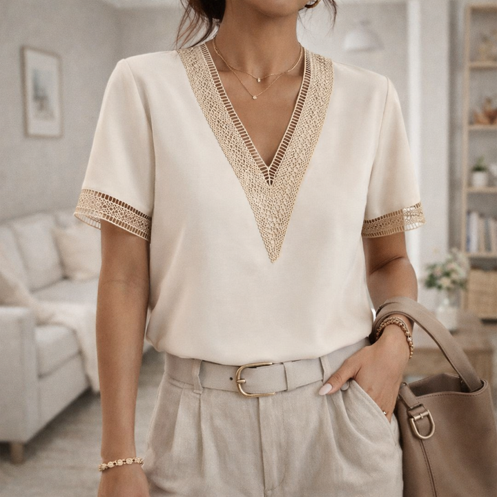 Women's elegant V-neck top with delicate lace trim, perfect for spring and summer fashion.