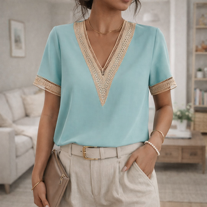 Elegant women's short-sleeve V-neck blouse with delicate lace trim detail.