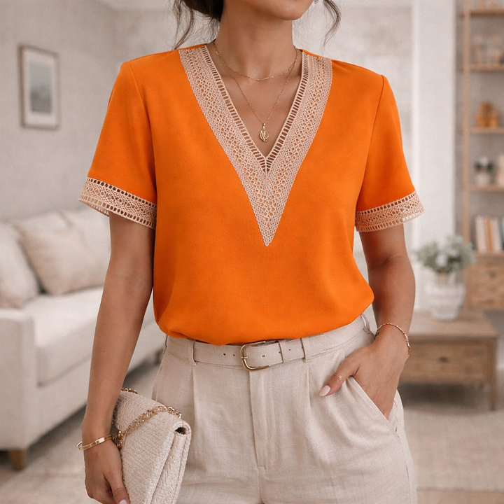 Feminine women's top with elegant V-neck, short sleeves, and delicate lace trim for versatile styling.