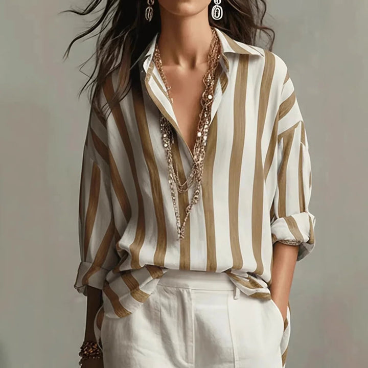 Versatile women's striped blouse with open collar. Elegant long-sleeve top for office wear or stylish casual outfits.
