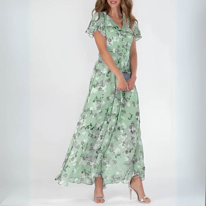 Elegant women's maxi dress with romantic watercolor floral print, ideal for wedding guests or summer parties.