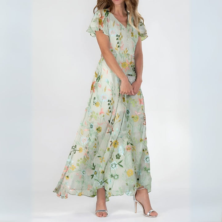 Vibrant watercolor floral print on a flowing women's maxi dress, perfect for a chic and comfortable summer look.