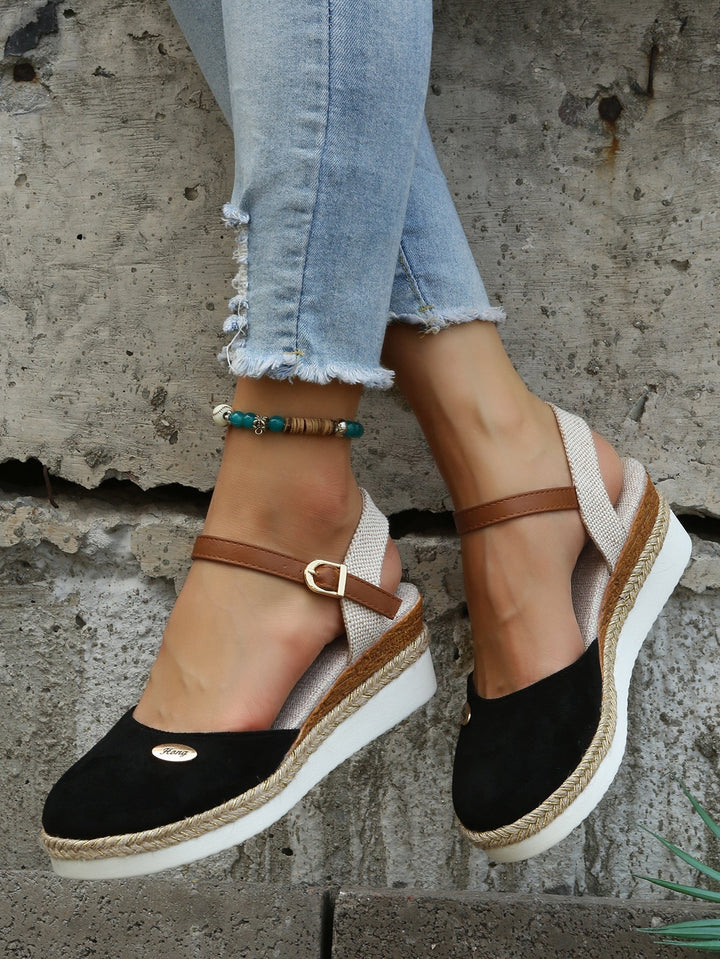 Close-up of women's comfortable woven sandals with cushioned sole. Stylish open-toe summer fashion footwear.