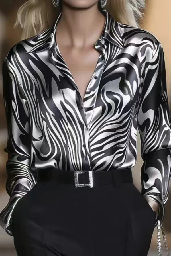 Stylish women's button-down shirt with bold zebra print. Long sleeve, elegant work blouse for sophisticated fashion.