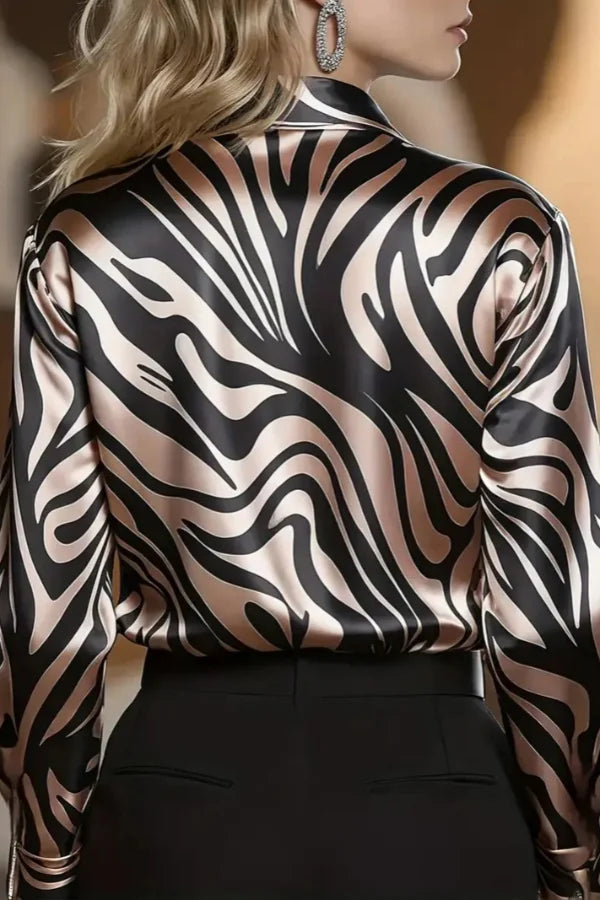 Women's long-sleeve button-down shirt with stylish zebra print. Sophisticated work blouse for elegant and modern fashion.