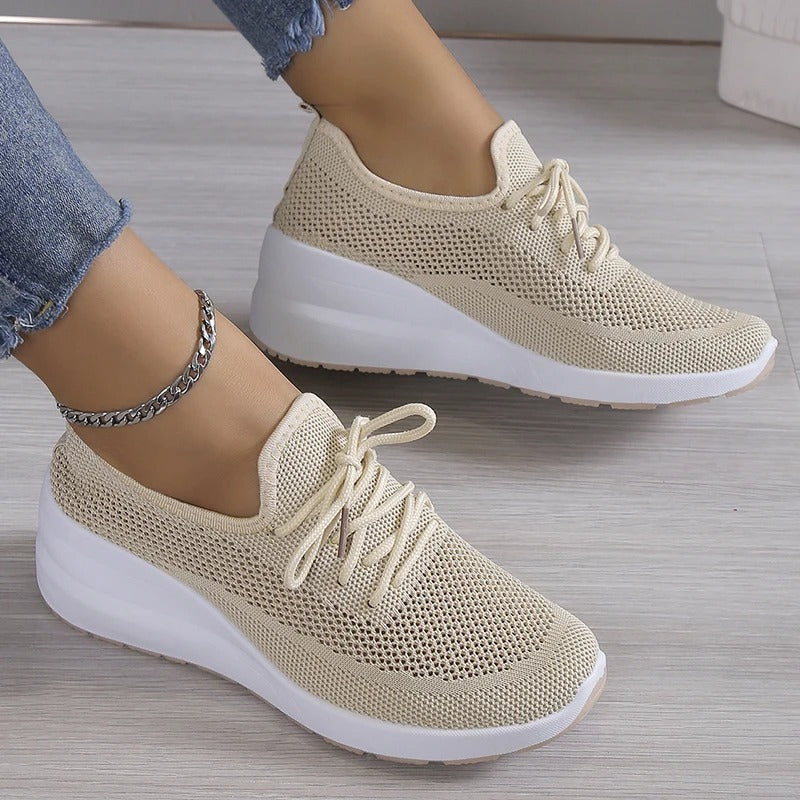 Women's elevated platform wedge sneakers in a sleek design, perfect for fashion-forward casual wear & comfort.