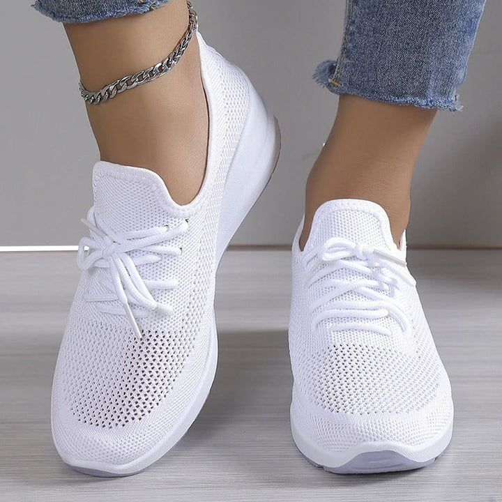 Modern women's elevated wedge sneakers with a comfortable platform sole, ideal for fashion-forward casual footwear.