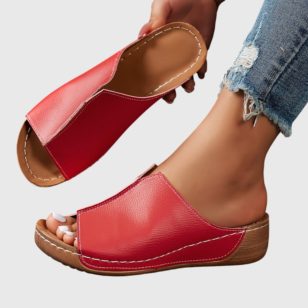 Women's comfortable flat sandals with adjustable straps, offering all-day support & an open-toe.