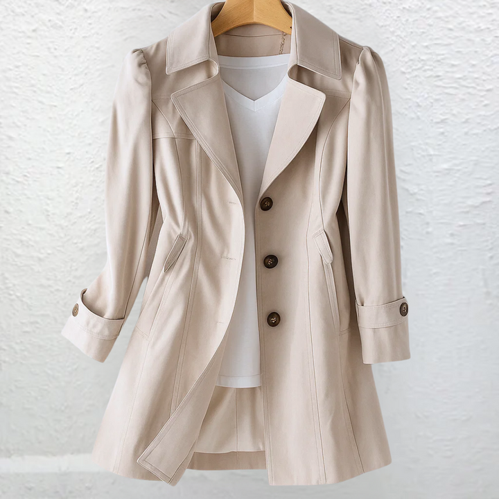 Women's fitted belted trench coat with structured collar in a classic, elegant style for fall & spring professional attire.