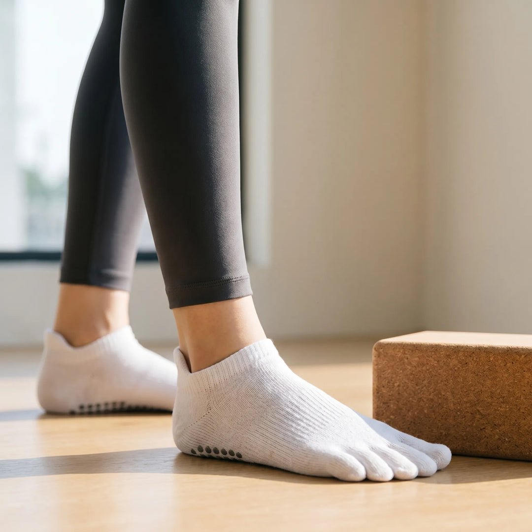 Women's five-toe grip yoga socks for enhanced balance and stability during Pilates and studio workouts.