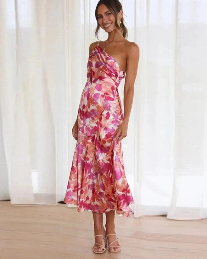 Women's floral asymmetric midi dress with flowing hem, perfect for summer elegance.