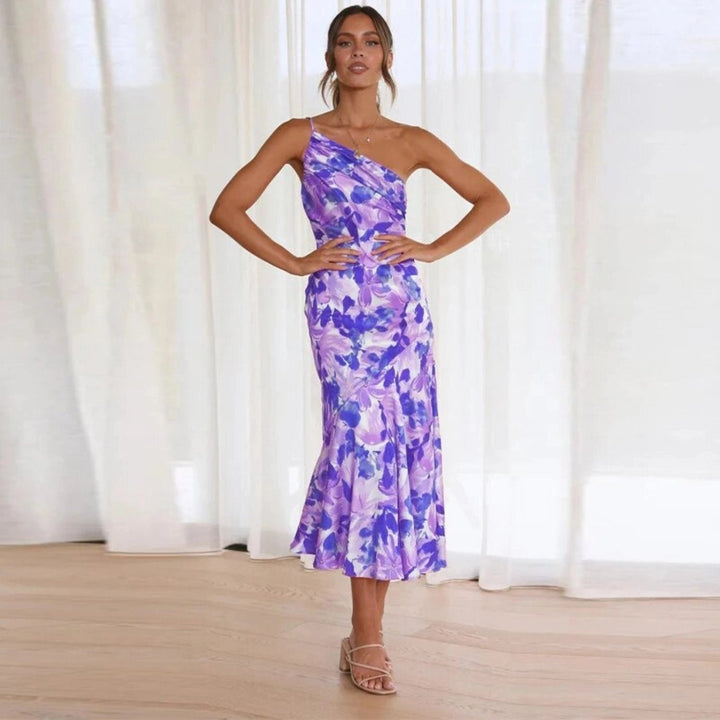 Printed sleeveless midi dress for women, showcasing a floral pattern & chic asymmetric flowing hem.