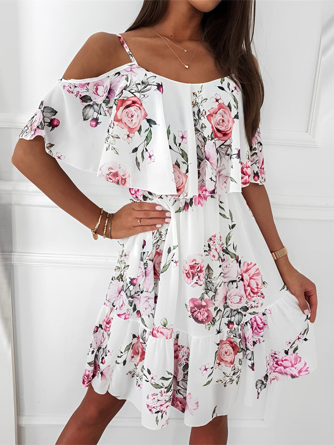 Women's floral cold shoulder mini dress with elegant ruffle trim. Perfect for summer parties & vacations.