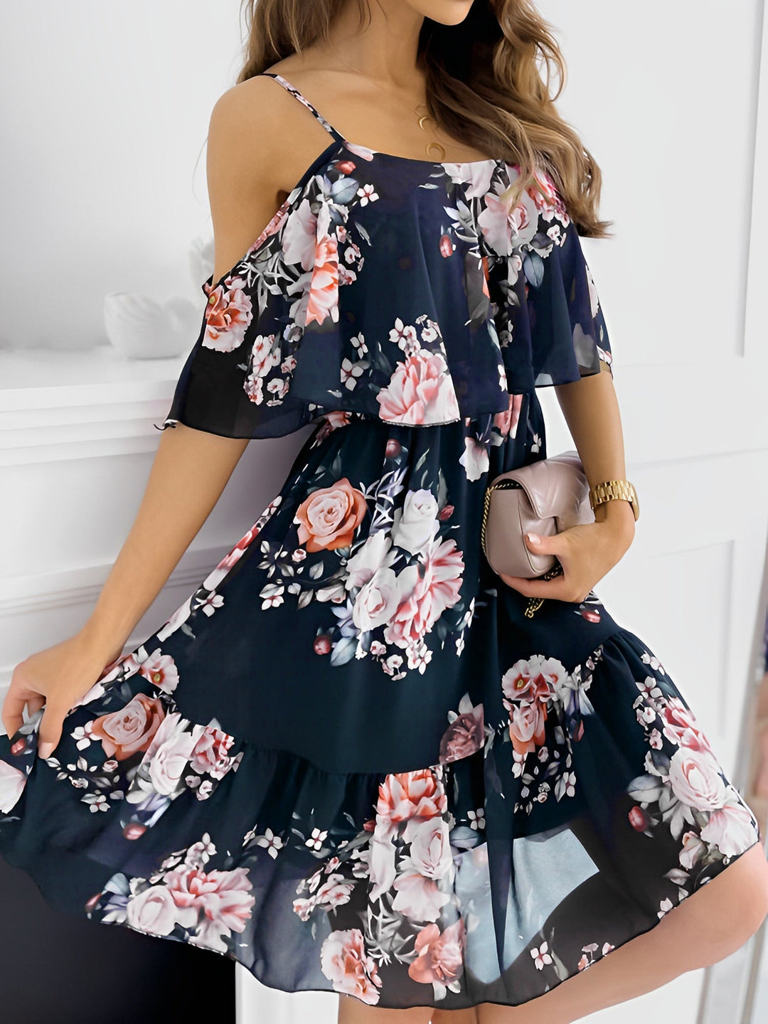 Woman in an elegant floral cold shoulder mini dress, perfect party attire for a summer celebration.