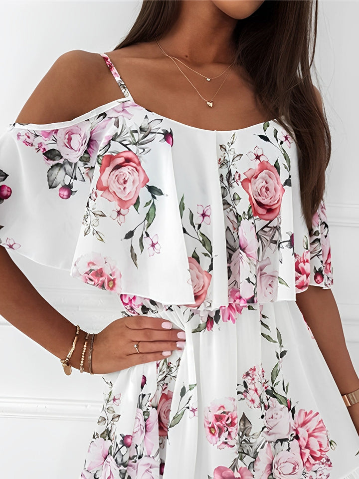 Close-up of delicate ruffle trim on women's floral cold shoulder mini dress, highlighting flowy style.