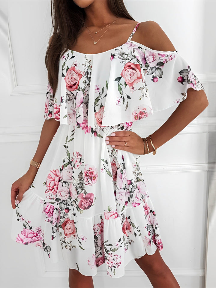 Vibrant floral pattern on a women's cold shoulder mini dress. Ideal for spring fashion & casual wear.
