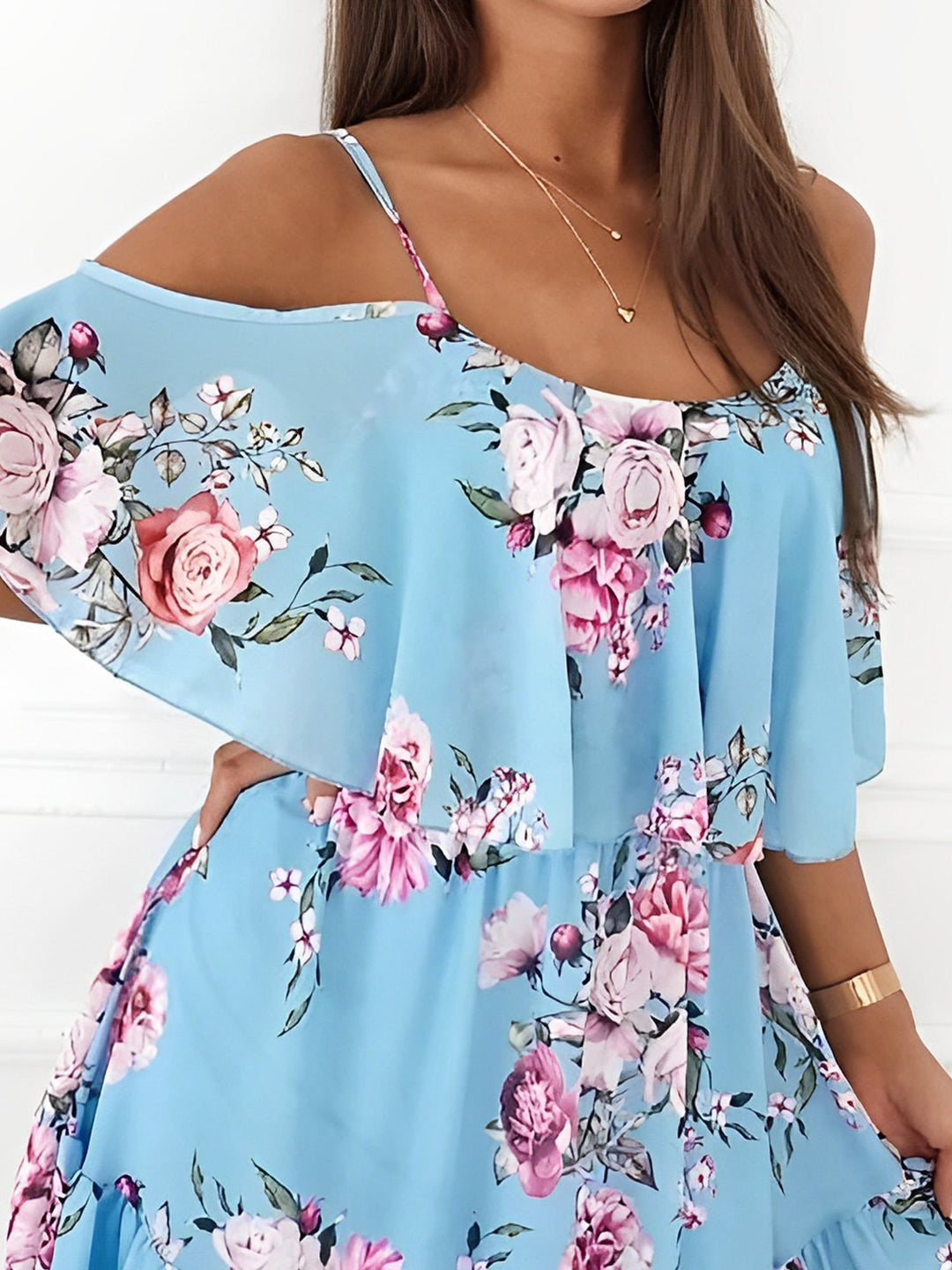Full length front view of women's floral cold shoulder mini dress with ruffle trim, a key spring fashion.